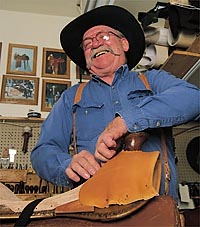 Gill stretches and tacks the leather to the "tree." photo by David N. Seelig