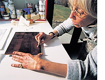 photo by David N. Seelig  Grosvenor opens up areas on the plate that have been covered with a resist medium so they can be etched later.