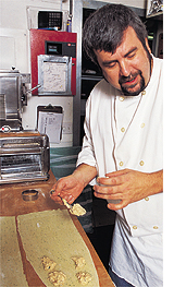 Brent Rasmussen, chef de cuisine at Baci Italian Cafe, prepares Baci tomato-chevre ravioli. Photo by David N. Seelig