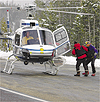 Heli-ski pilot Lon Stickney collects paramedic Chris Stephens and guide Bozo Cardozo enroute to rescuing Steve Waltcher after an avalanche on Titus Ridge. Photo by Willy Cook